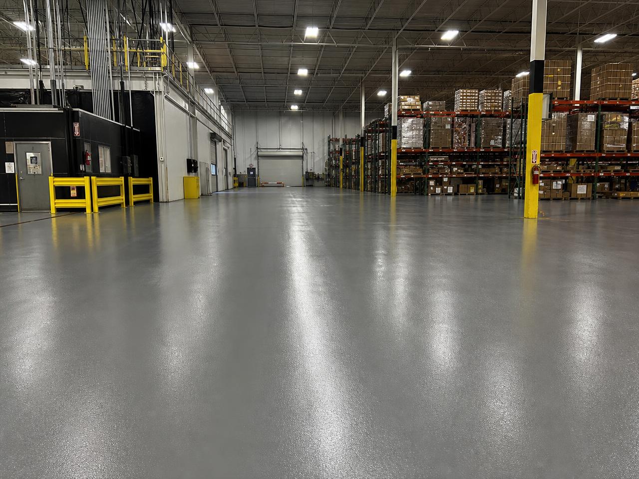 Industrial concrete slab coated with a durable polyurea floor system