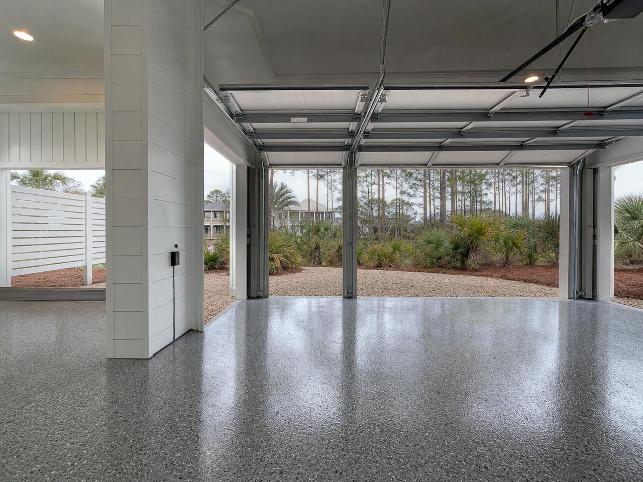 Alabama Gulf Coast garage with a gray flake coated slab under humid overcast sky