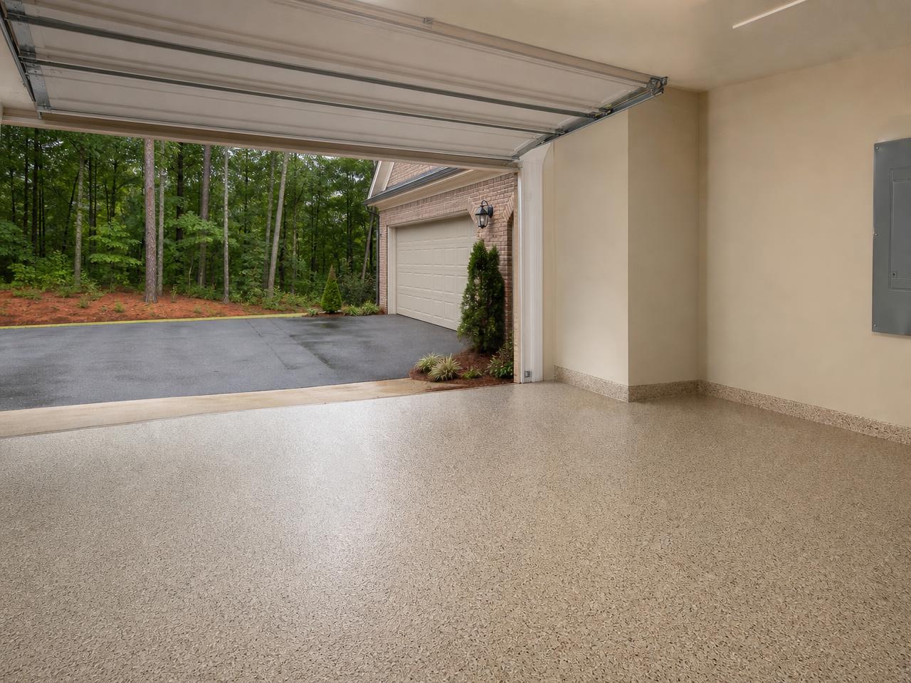 Atlanta area garage with a tan flake coated floor and Georgia red clay outside