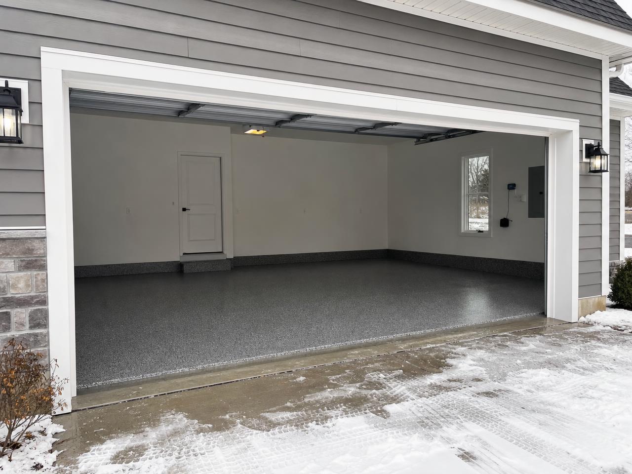 Columbus Ohio garage with a charcoal flake coated floor and snow outside