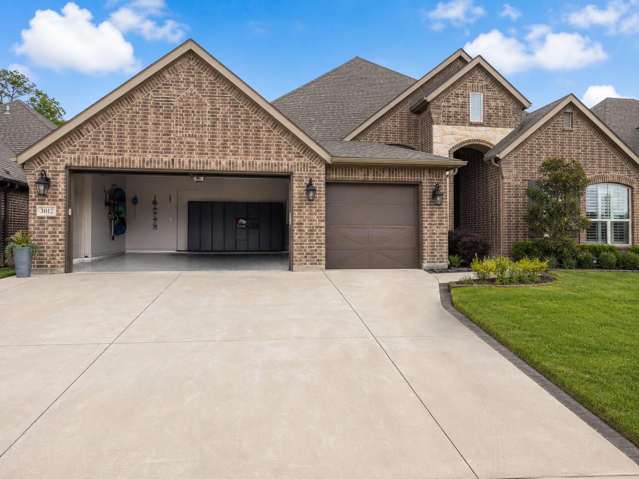 North Texas suburban home with a wide two-car garage and concrete driveway