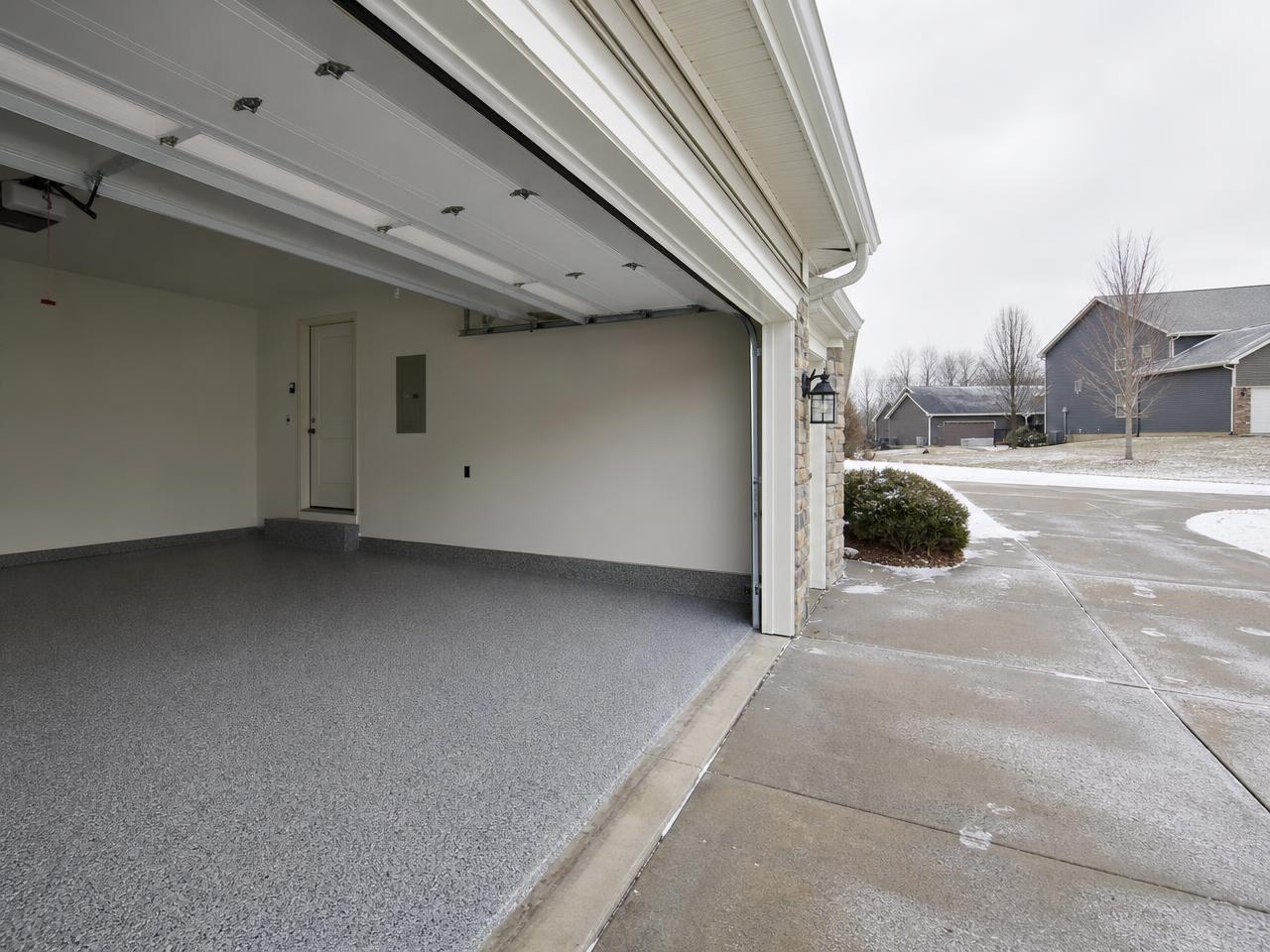 Kansas City garage with a gray flake coated floor and a salted winter driveway
