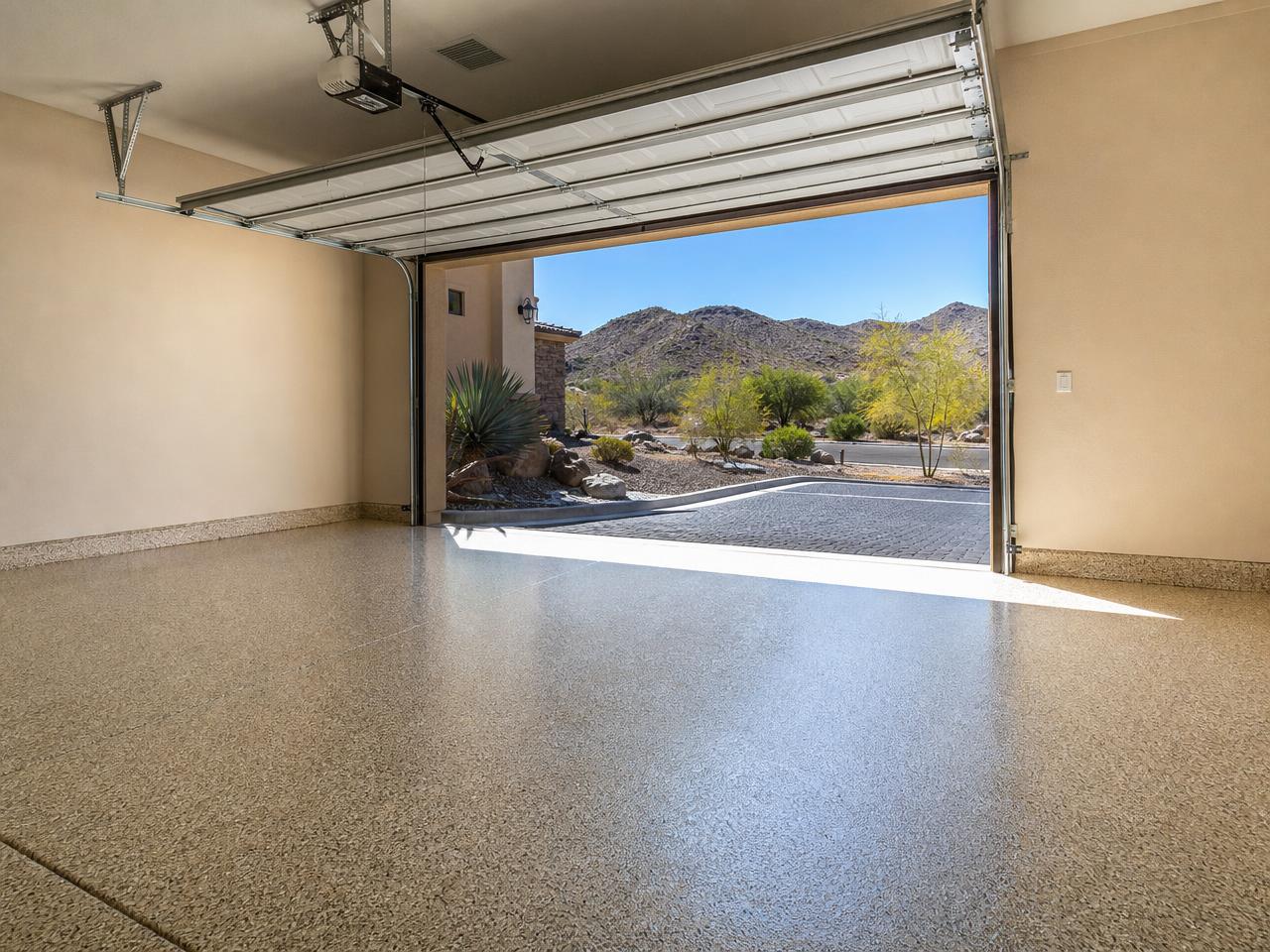 Las Vegas desert home garage with a tan flake coated floor and mountains outside