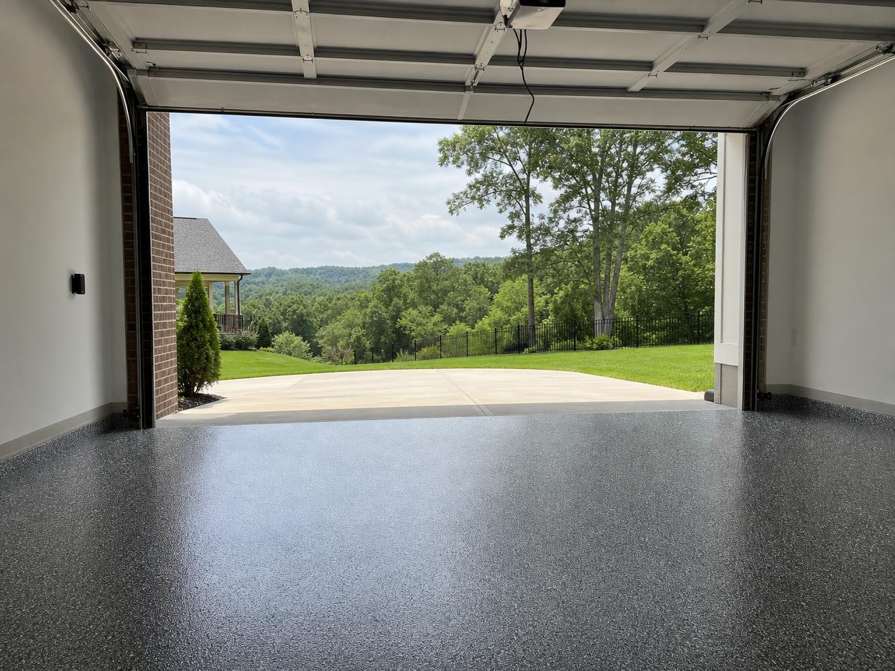 Nashville area garage with a dark flake coated floor and rolling green hills outside