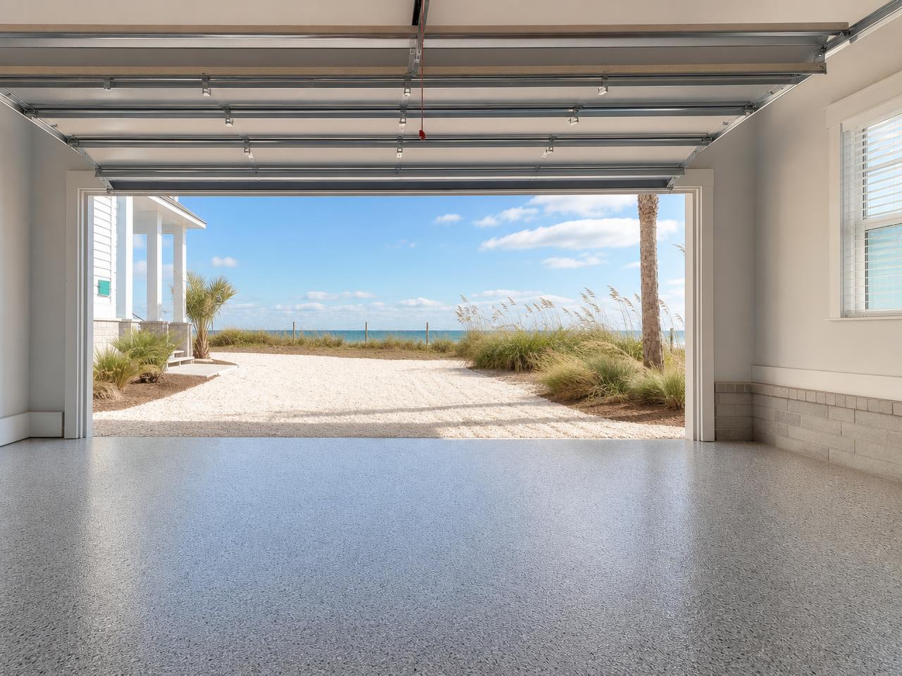Northwest Florida beach home garage with a coated floor and sea oats outside