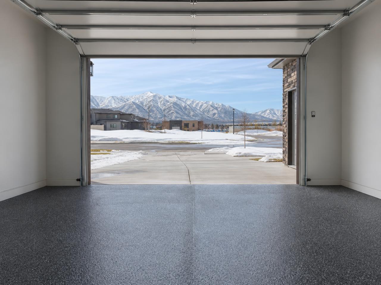 Salt Lake City garage with a gray flake coated floor and snow capped mountains outside